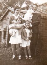 My parents, Rosemary (holding me), Sue and Mary Lou, outside the cubby house in Albany, in 1945